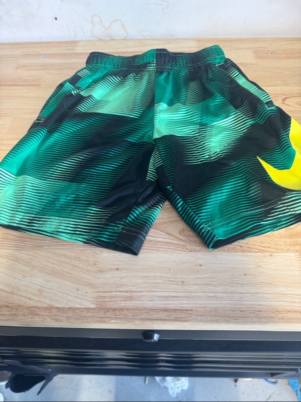 Nike Green and Black Striped Athletic Shorts with Yellow Swoosh